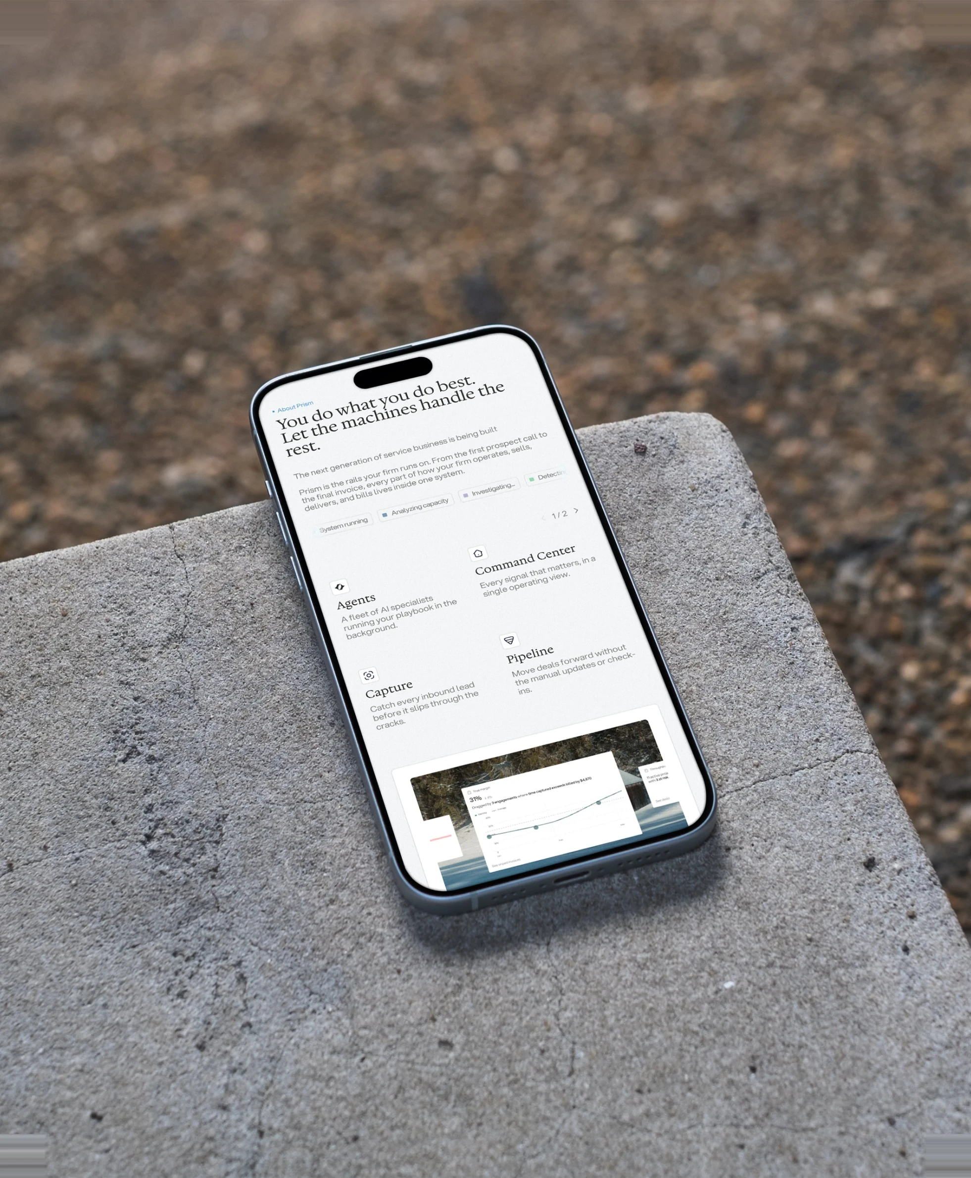 A phone resting on a concrete ledge, showing the Prism site