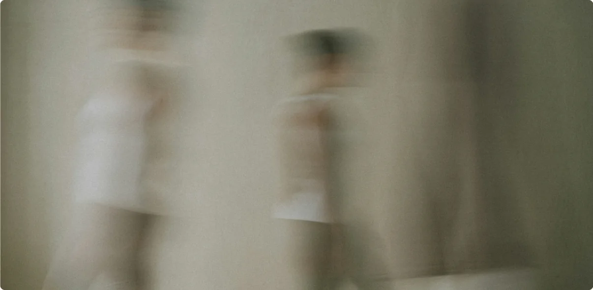 Two figures blurred by their own movement