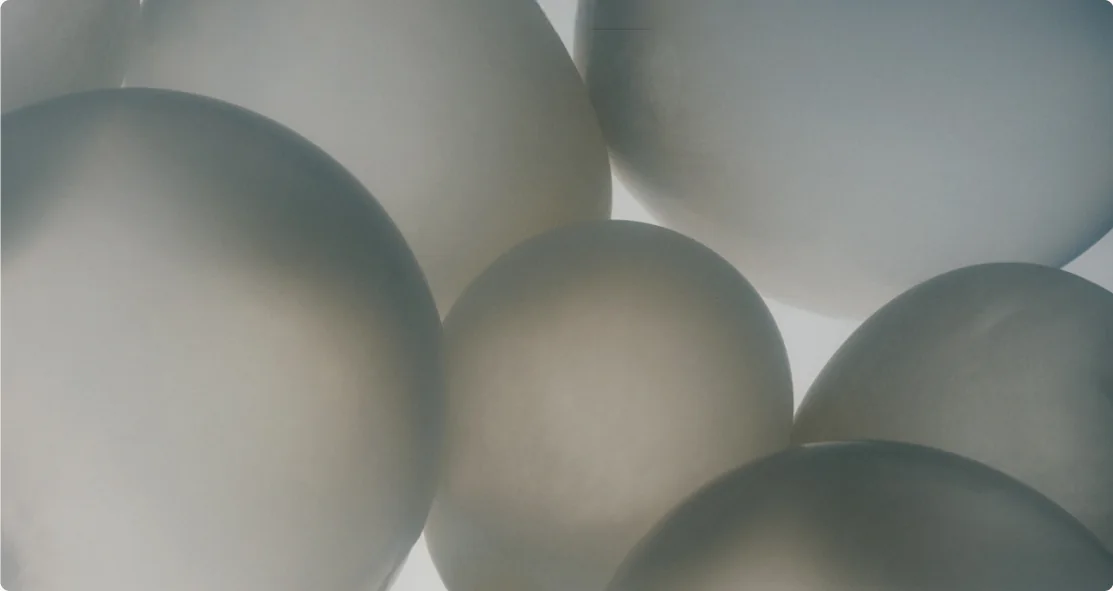 Pale spheres crowded together in soft light