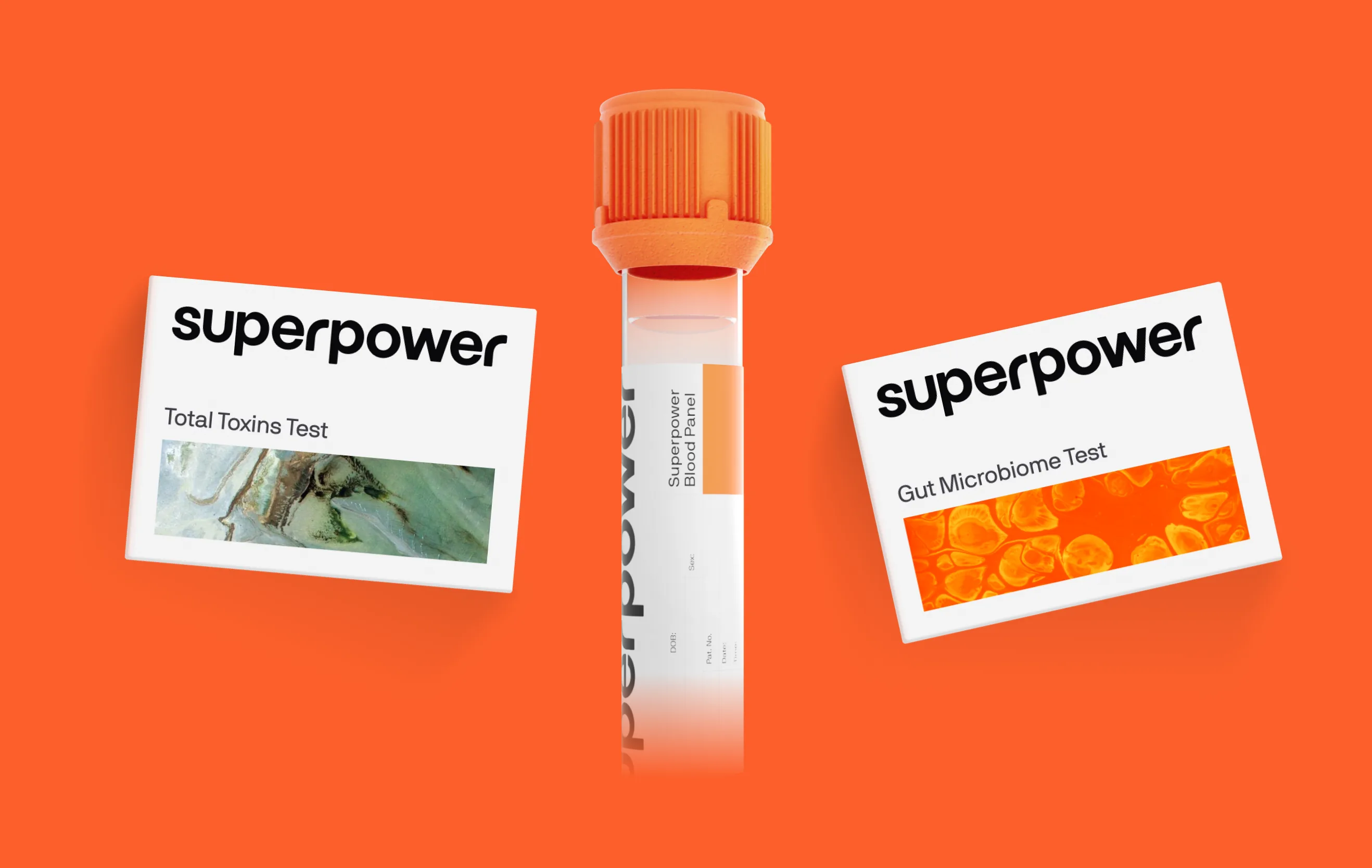 A Superpower blood collection tube standing between two test kits, the Total Toxins Test and the Gut Microbiome Test, on orange
